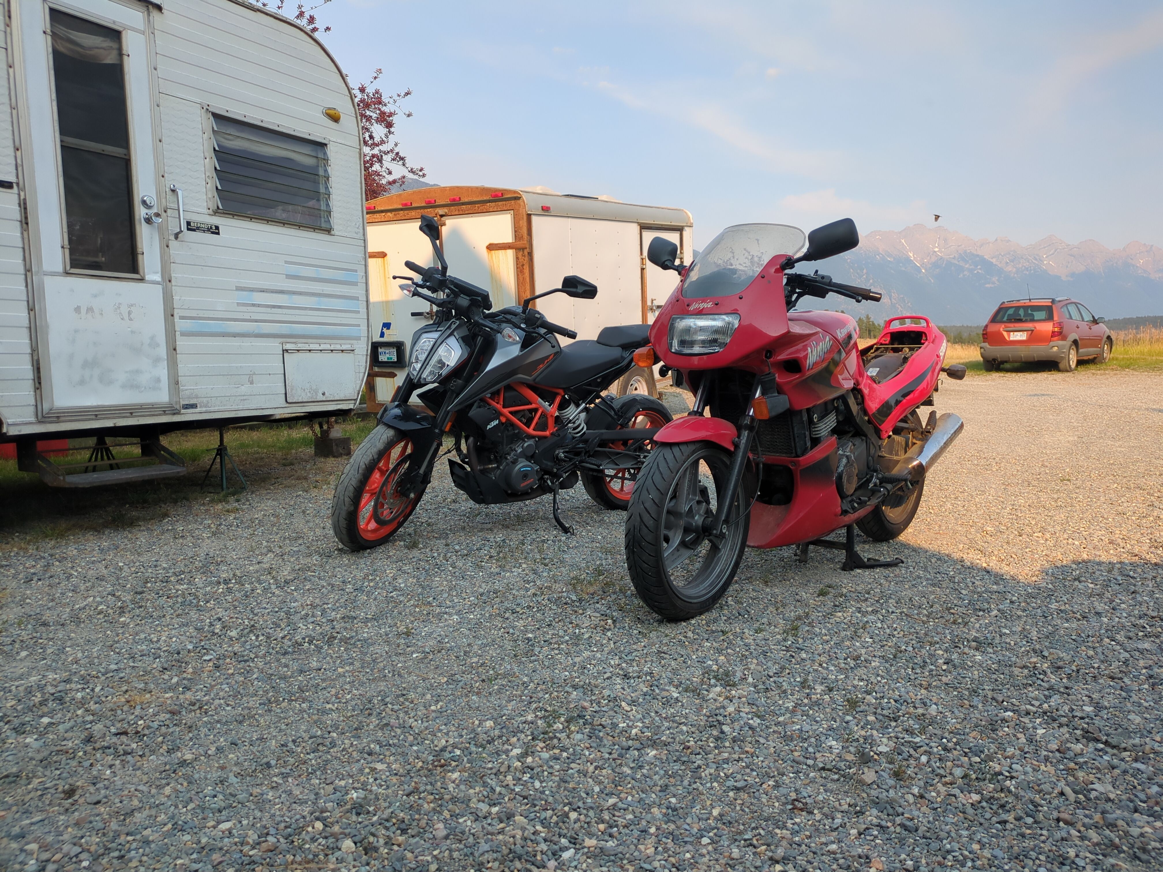 KTM Duke 390 and a Kawasaki EX500 taken out of the garage for maintenance.